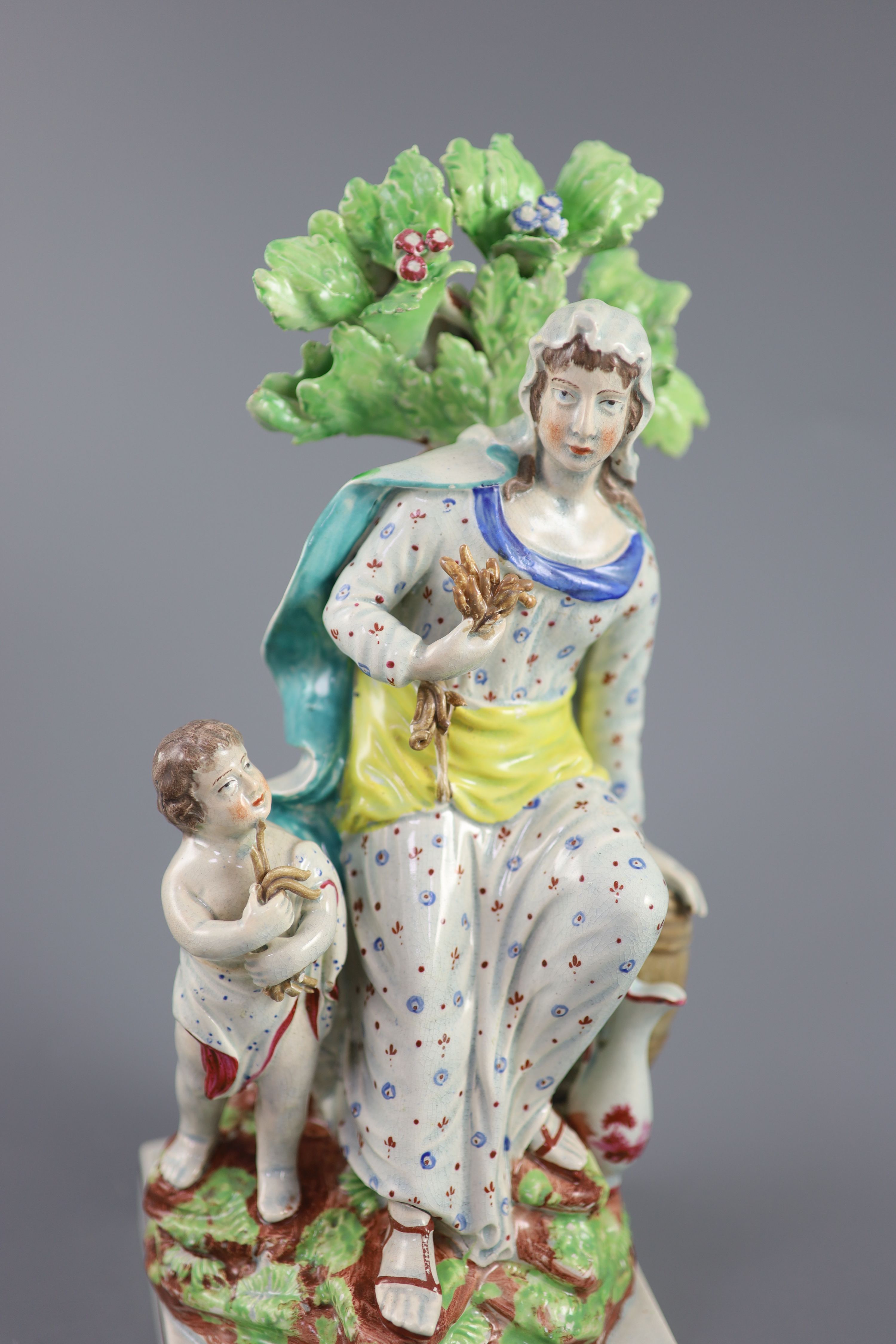 A Ralph Wood type group of a widow of Zarepeth with oil and barrel, c.1790-1810, 27.5cm high